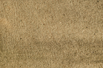 The beige colored wall with the cracked stucco texture background.