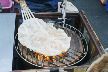 White rice pancake cooked over fire