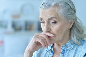 portrait of sad senior woman at home