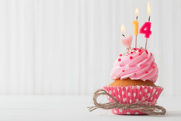pink cupcake on white wooden background