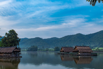 Naklejka premium The wooden raft in the water reservoirs and mountain views.