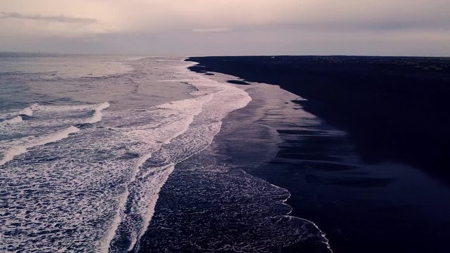 Drone video of waves hitting the black sand beach in Landeyjah&ouml;fn Iceland
