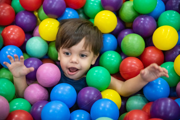 Fototapeta na wymiar Cute baby boy toddler - in the ball pool