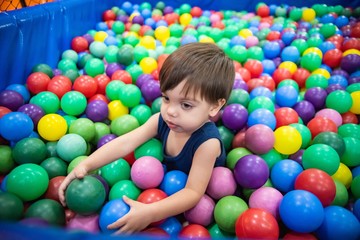 Fototapeta na wymiar Cute baby boy toddler - in the ball pool