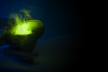 Happy halloween, alchemy and magic spell potion concept with a pot or calderon boiling a green...