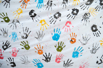Colorful hand prints on white cloth