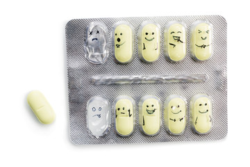packaging of tablets with yellow pills and painted emotions isolated on white background.