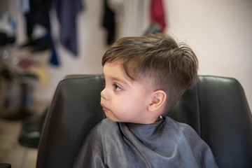 Cute baby boy toddler - cutting hair.