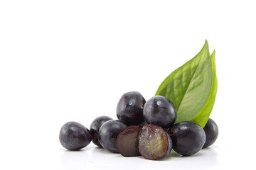 Fresh black grapes on white