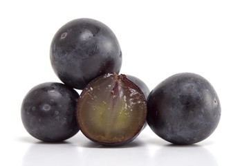 Fresh black grapes on white