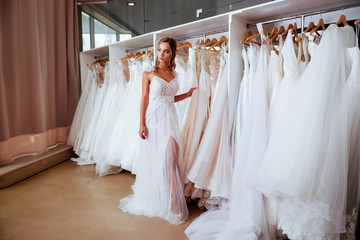 Beautiful bride is trying on an elegant wedding dress