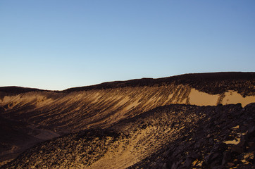 Fototapeta na wymiar Black dunes and moutains on the Black desert in Egypt
