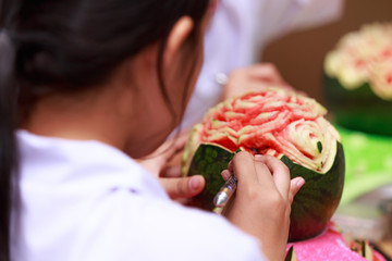 little girl carve fruit