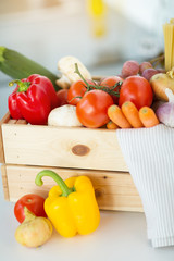 cooking, vegetarian food and healthy eating concept - close up of wooden box of fresh ripe vegetables