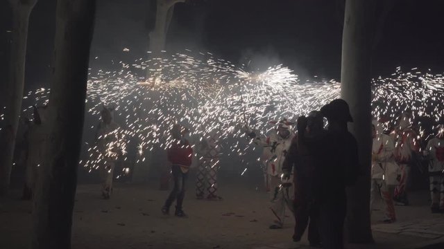 Traditional correfoc performance. In the correfoc, a group of individuals will dress as devils or Diables and light fireworks - fixed on devil's pitchforks