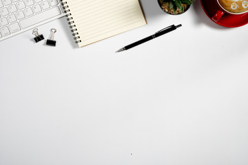 Workspace with computer, colour pencils and coffee mug on white background. Flat lay, top view
