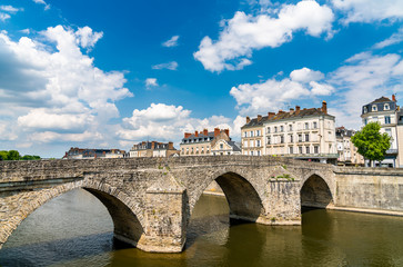 Fototapeta na wymiar Old stone bridge across the Mayenne River in Laval, France
