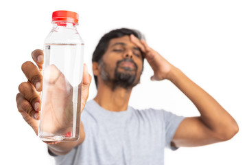 Focused water bottle held my man touching forehead