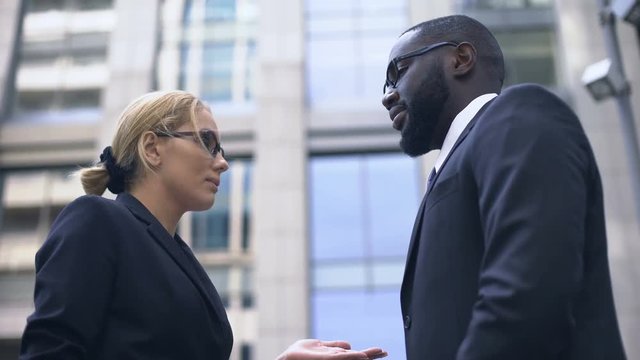 Female boss scolding subordinate, employee justifying himself, business ethics