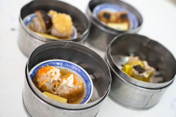 Dim sum on a food shelves, various Chinese steamed dumpling in bamboo basket steamer in Chinese restaurants.Yumcha or Dimsum