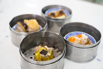 Dim sum on a food shelves, various Chinese steamed dumpling in bamboo basket steamer in Chinese restaurants.Yumcha or Dimsum