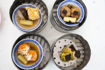 Dim sum on a food shelves, various Chinese steamed dumpling in bamboo basket steamer in Chinese restaurants.Yumcha or Dimsum