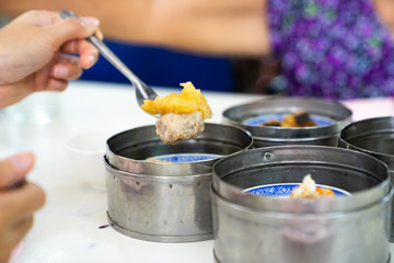 Dim sum on a food shelves, various Chinese steamed dumpling in bamboo basket steamer in Chinese restaurants.Yumcha or Dimsum