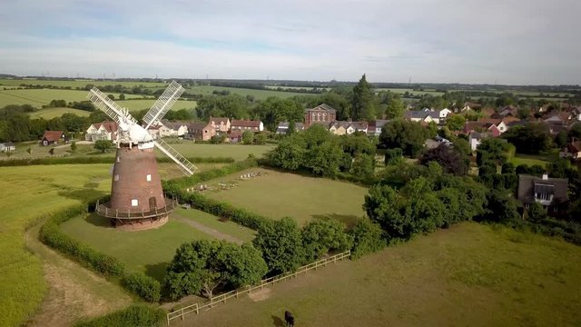 Thaxted Village and windmill, Essex, England. 4k aerial video footage rising to reveal the Essex village of Thaxted and its landmark windmill nestled in the heart of the English countryside.