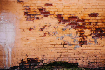 Old brick is peeling paint. Wall texture
