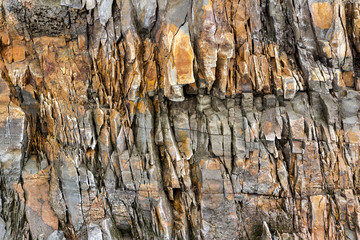 Granite rock face, stone texture and background.