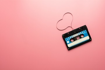 black tape cassette on pink background.