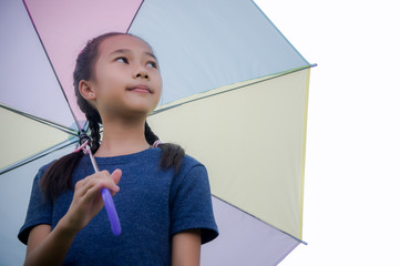 little girl's hold umbrella smile and looking at on the  rainy season