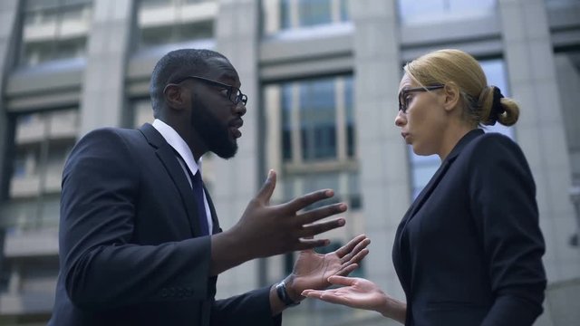 Male boss scolding subordinate, employee justifying herself, business ethics