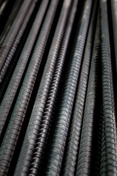 Black metal rods for reinforcement concrete building construction close up.