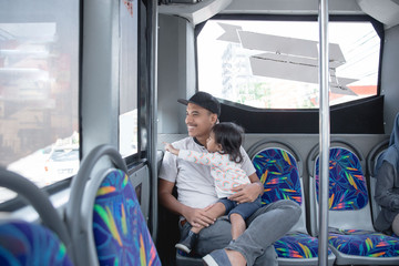 father and daughter in a public transport 