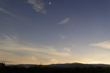 Paisaje de atardecer con estrellas en el cielo