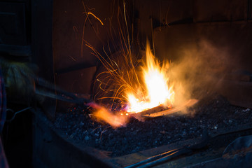 Blacksmith forging iron in workshop