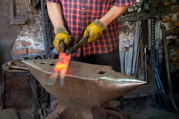 Hot iron forging on anvil. Handmade blacksmith