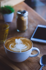 coffee hot drink cappucino latte art on wood vintage table , coffee time on wood background cafe