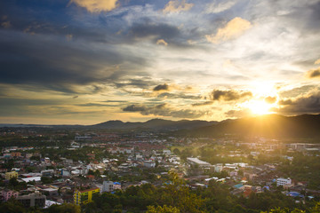 Fototapeta premium Landscape of down town and mountain during the sunset.