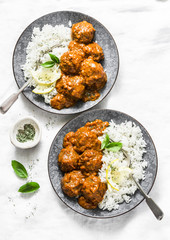 Lentils vegetarian roasted meatballs with curry sauce and rice - healthy lunch on light background,...