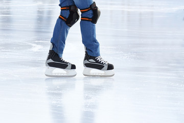 feet rolling on skates man on the ice rink