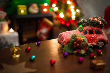 Christmas decoration background with Christmas tree on top of red car and ornaments.
