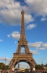 Very high Eiffel Tower and the blue sky with clouds