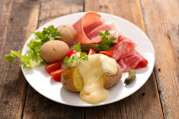 raclette cheese with potato and meat