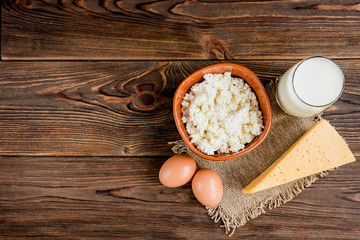 Obraz na płótnie Canvas Cottage cheese, cheese and glass of milk on wooden background. Dairy products.