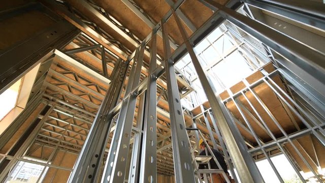 Skeleton Steel Frame of the Residential Building and Some Worker.