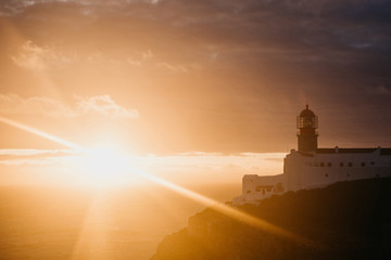View of the lighthouse and cliffs at Cape St. Vincent in Portugal at sunset. The most south-western...