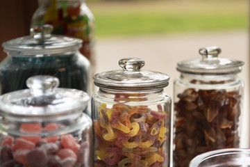Assorted gummies sweets candies in glass jars