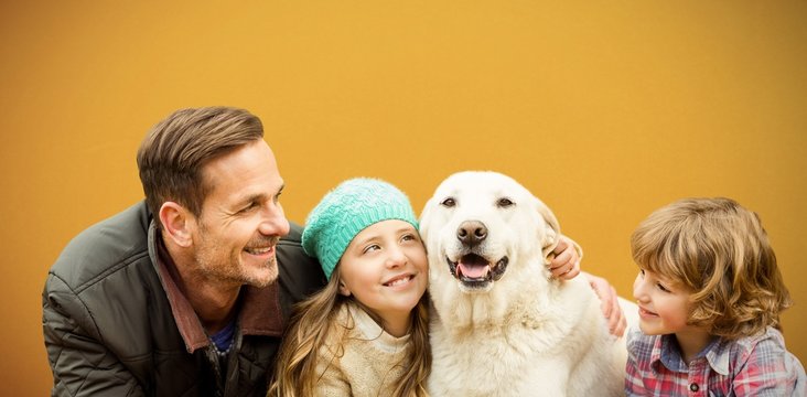 Composite image of  happy family enjoying with dog in leaves